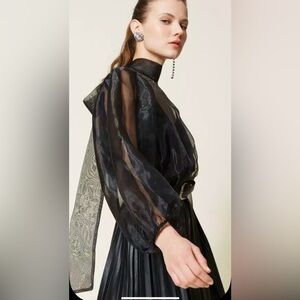 NWOT. CeCe Black Sheer Top size small. Beautiful and elegant.